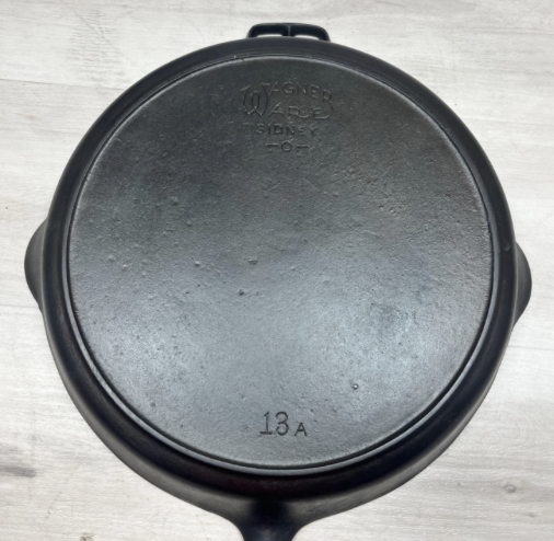 Bottom of Wagner number 13 cast iron skillet with heat ring, no incised catalog number. Sold for $800.